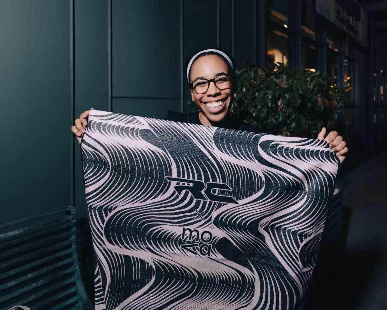Atlanta Run Club member holding mova sponsored CleanRide seat towel