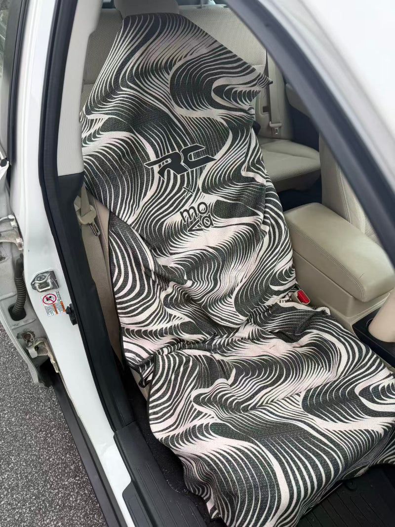 Car seat cover with black and white pattern on a car seat