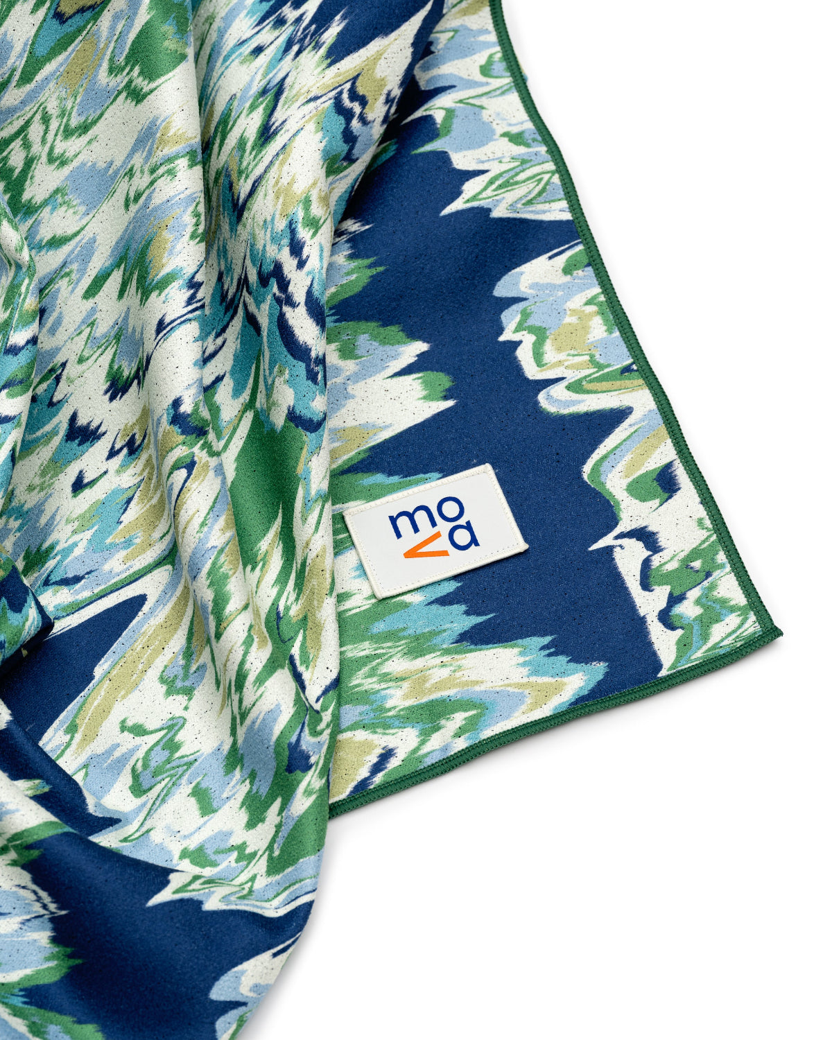 Navy blue fabric with green and white floral pattern, Moa logo visible